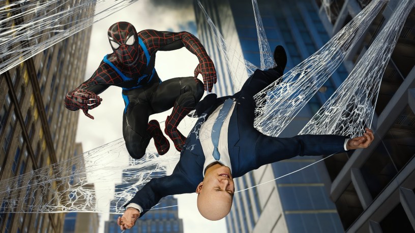 Peter Parker, wearing the Spider-Man "Spider-Verse" suit, swings through the city while webbing up a bald man in a suit, suspending him between skyscrapers.