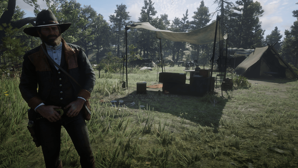A Red Dead Redemption 2 character standing in front of a camp with tents, supplies, and horses in a forested clearing.